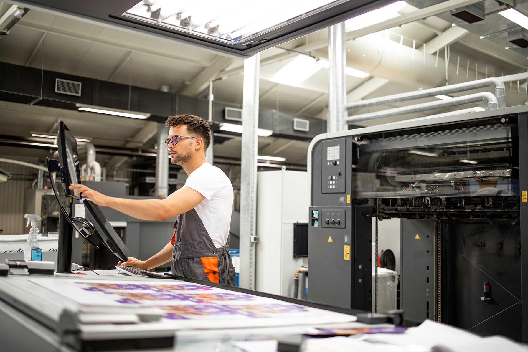 print-house-worker-setting-parameters-modern-offset-printing-machine